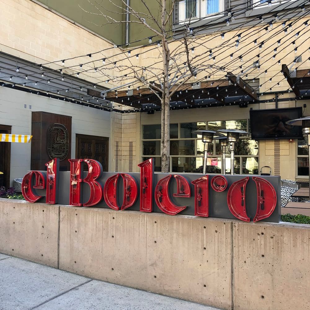 El Bolero restaurant exterior with illuminated sign and outdoor seating area.