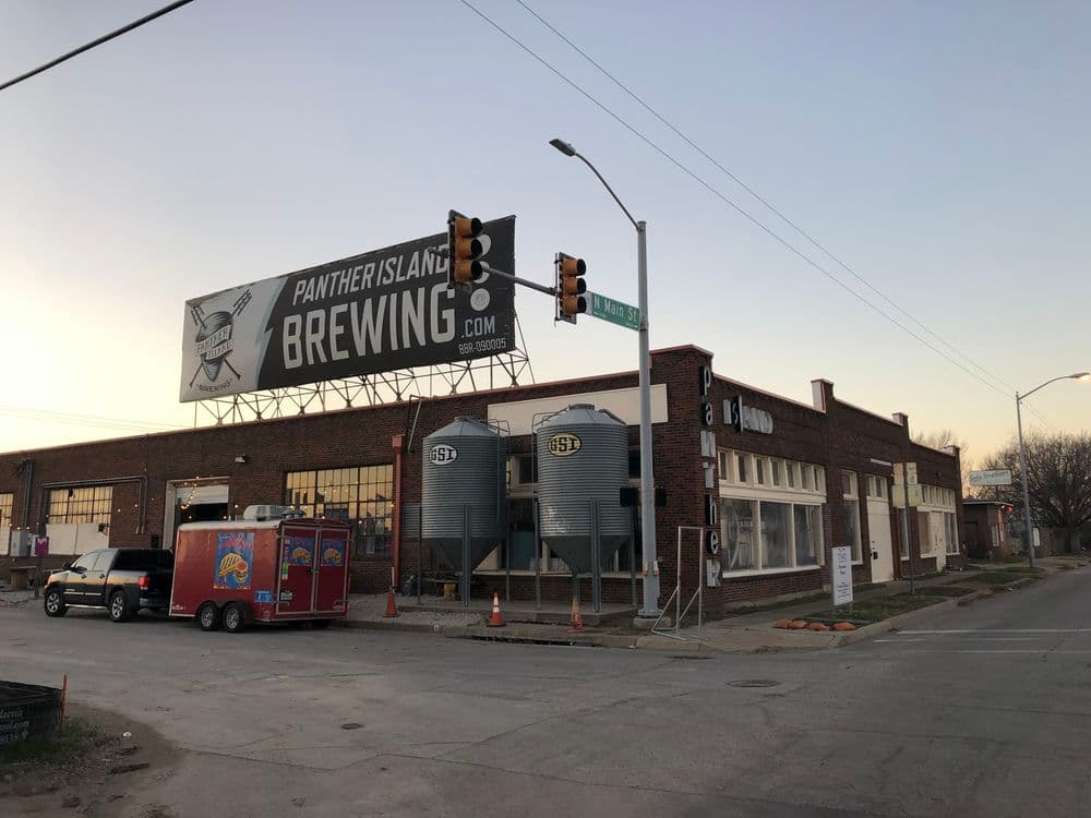 Panther Island Brewing exterior with silos and food truck at sunset, Fort Worth, Texas.