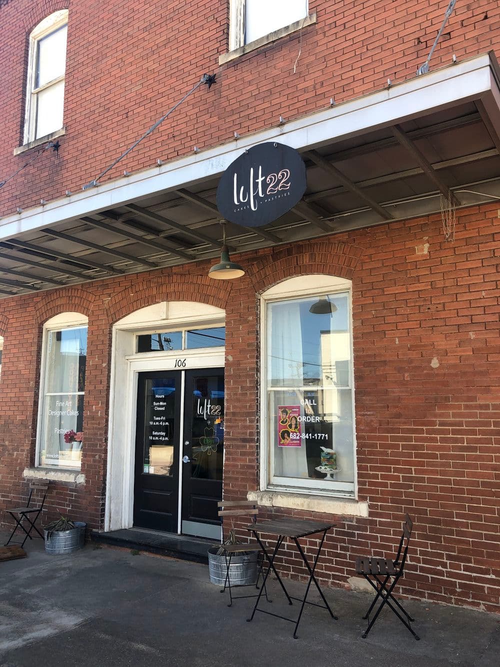 Entrance of Lift 22 restaurant, featuring a black sign and brick façade, located at 106.
