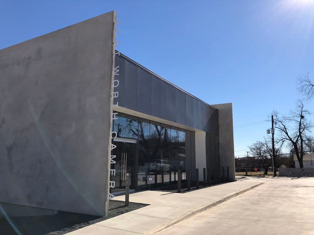Modern Fort Worth Camera building with sleek design and clear blue sky in background.
