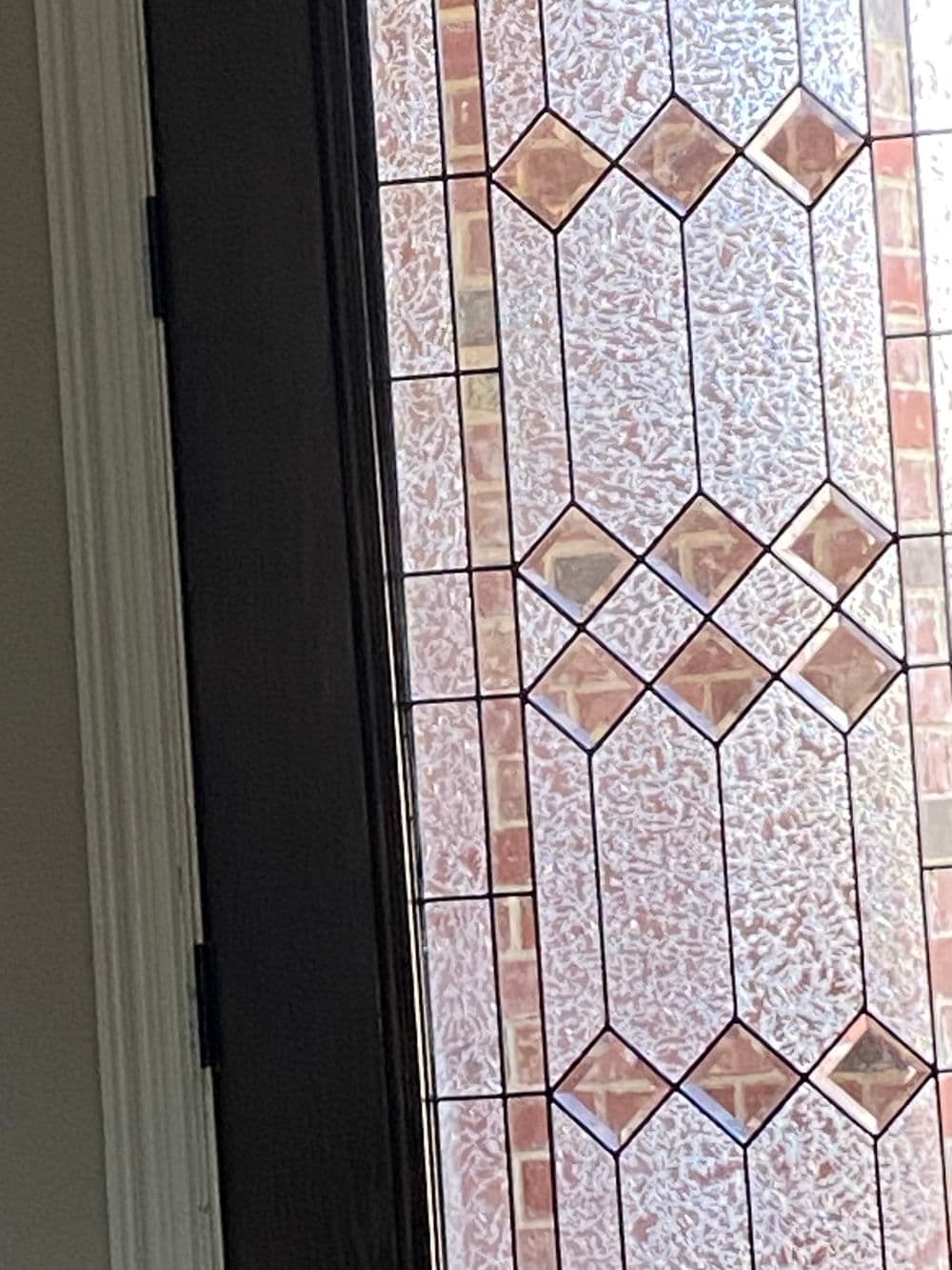 Stained glass door panel featuring geometric patterns and rich colors.