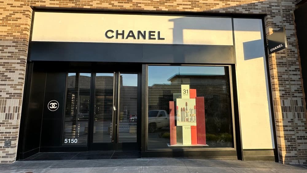 Chanel store exterior showcasing iconic branding and a modern display window design.