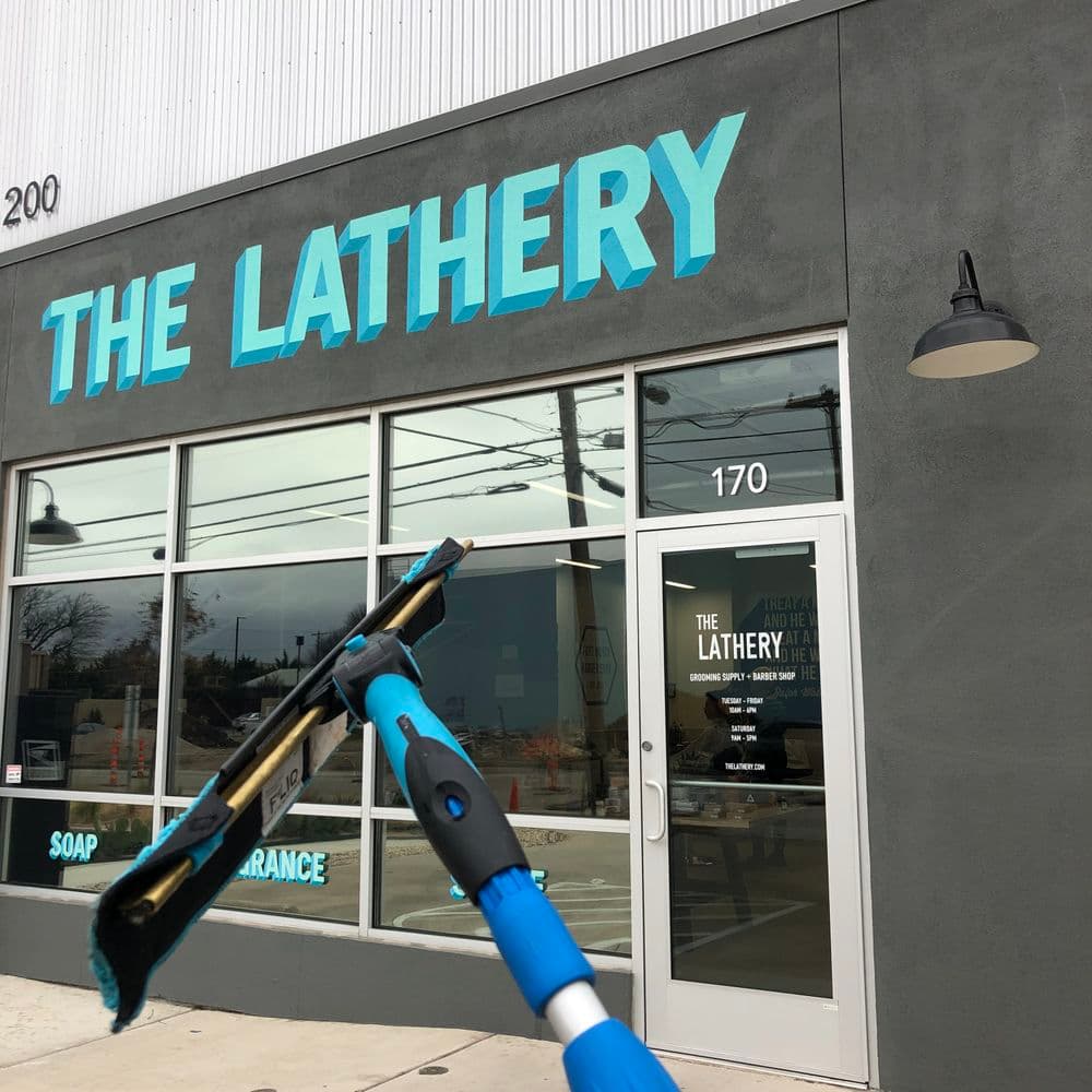 Exterior of The Lathery shop with blue signage, cleaning tools in foreground.